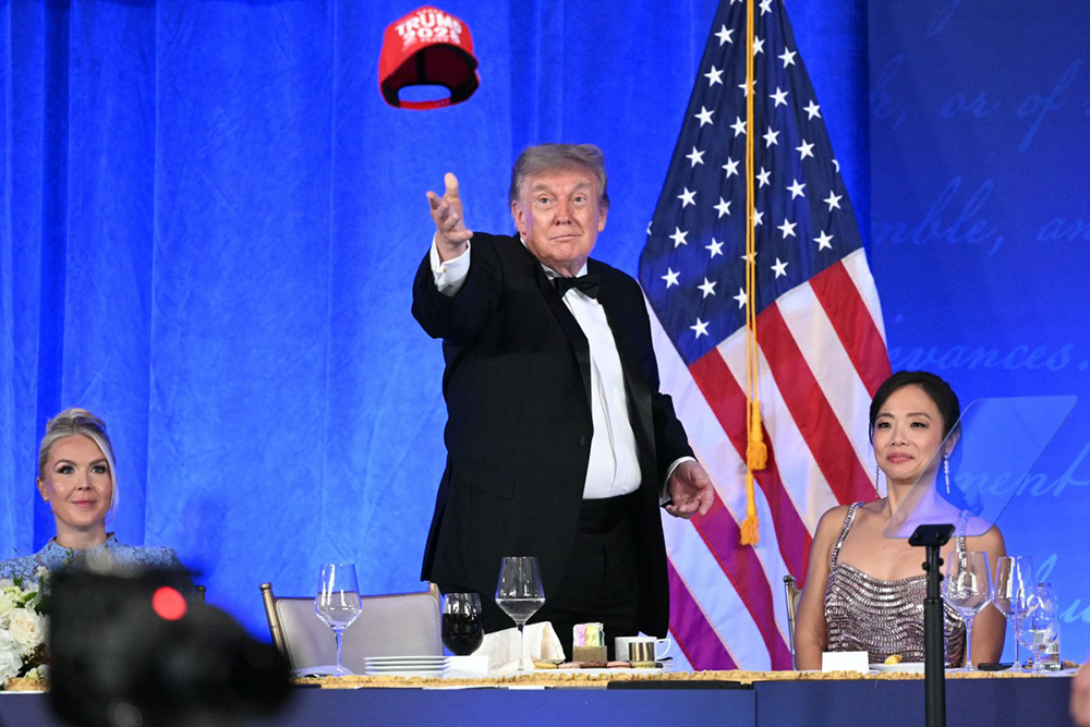 US President Donald Trump throws his "Trump 2028" hat during the 2026 White House Correspondents' Association (WHCA) Dinner at the Waldorf Astoria in Washington, DC, on July 24, 2026. 