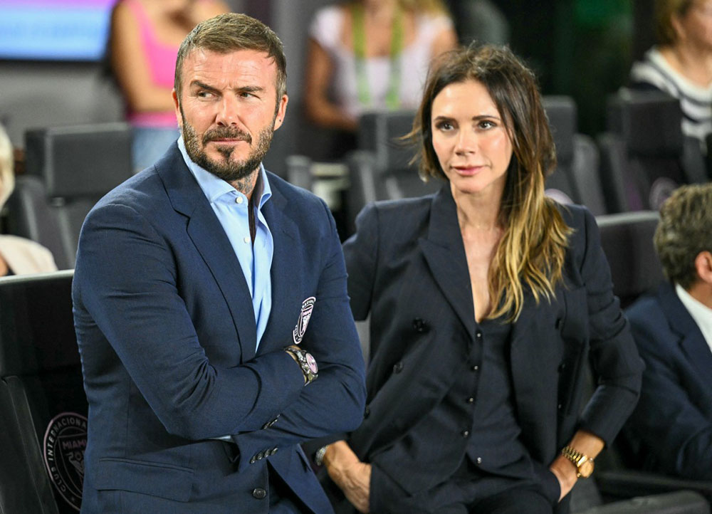 Inter Miami's president and co-owner David Beckham and his wife Victoria Beckham watch from the sidelines before the start of the Major League Soccer (MLS) playoff football match between Inter Miami and Nashville SC at Chase Stadium in Fort Lauderdale, Florida on October 24, 2025. (Photo by CHANDAN KHANNA / AFP)