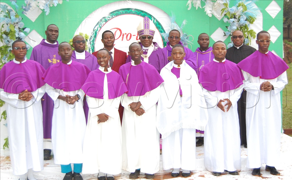 Archbishop Paul Ssemogerere (wearing a mitre), shares a photo moment with the headteacher of Buddo SS (on the prelate;s immediate right), the clerics and mass servers after the mass of the celebration of the Pro-life Convention at Buddo SS. 