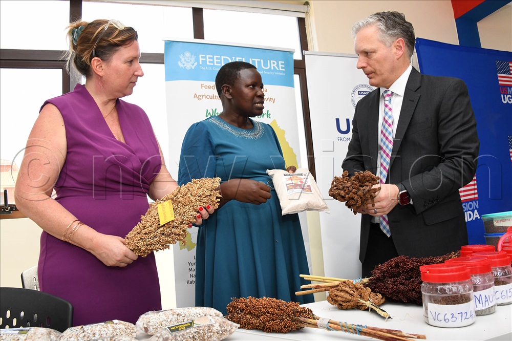 Scovia Adikini, a plant breeder and a team leader for dry land cereal research program at National Semi Arid Resources Research Institute one of the institutes under National Agriculture Research Organization in Uganda (centre) interacting with Richard Nelson USAID Uganda Mission Director after the launch of the seventh edition of the 'Report to the Ugandan People'. Adikini's research, focus on improving finger millet and sorghum productivity for food and nutritional security and income through breeding for varieties that are well adapted to biotic stress and with market quality traits. Looking on the left is Amy Beeler a Director at USAID Economic Growth office.