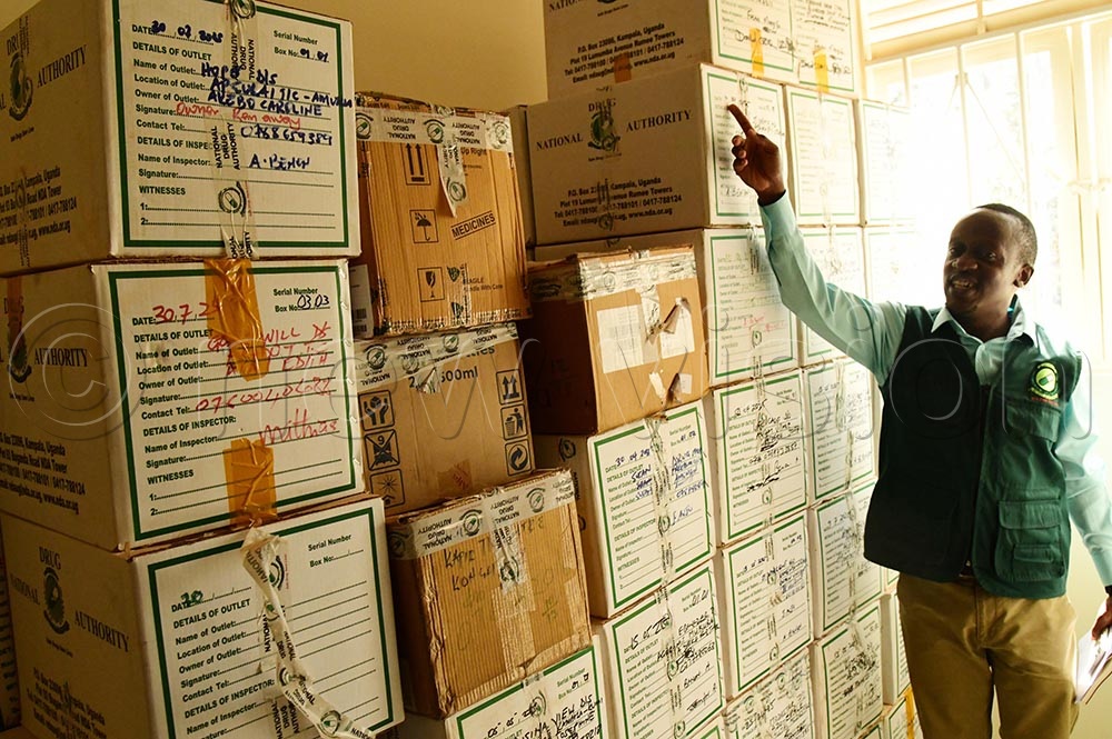 Dr Tom Makumbi showing the press some of the impounded drugs. (Credit: Godfrey Ojore)