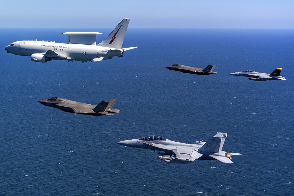 Royal Australian Air Force (RAAF) E-7A Wedgetail airborne early warning and control aircraft (top L) in formation flight with a pair of US Marine Corps (bottom C) and Royal Air Force (top C) F-35B Lightning IIs, an RAAF F/A-18F Super Hornet (top R) and RAAF EA-18G Growler electronic warfare aircraft (bottom R), over airspace in the Northern Territory of Australia during Exercise Talisman Sabre 2025. (AFP)