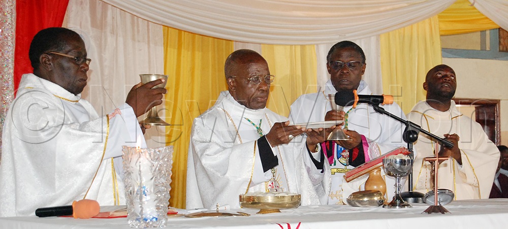 (L-R): Msgr. Dr Richard Kayondo, Apostolic Nuncio, Dr Augustine Kasujja, Bishop Lawrence Mukasa and Fr Kizito Ssembajjwe performing the Eucharistic rites during the memorial mass of the 5th death anniversary of Archbishop Cyprian Kizito Lwanga at Kyabakadde Catholic parish church, in Kyampisi Sub-County, Mukono district on Wednesday, April 15, 2026. (Photo by Mathias Mazinga)