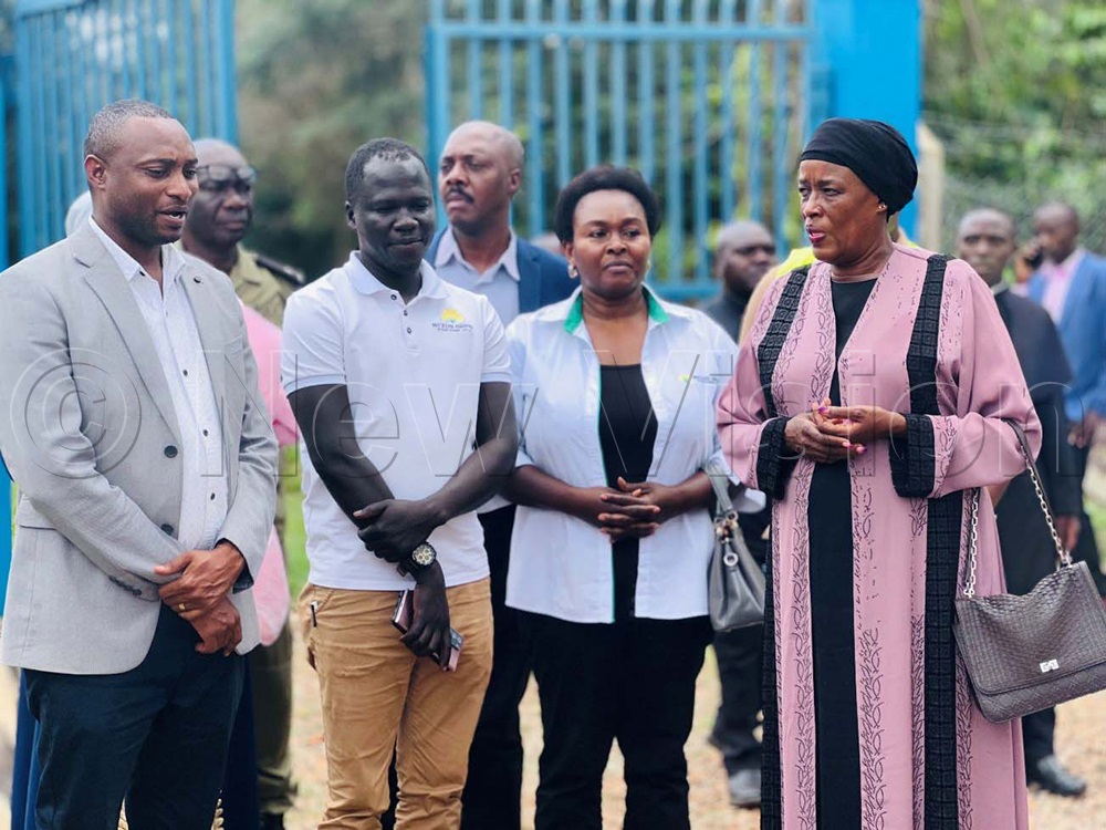 Eng. Umaru Ssekabembe (left), Project Engineer, reviews the operational readiness of the Bulaza Solar-Powered Water Supply System as State Minister for Water Aisha Sekindi (right) and other delegates look on during an inspection of the completed works. (Photo by Juliet Kasiyre)