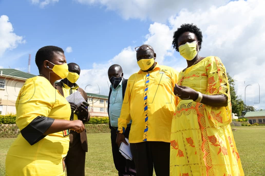 NRM SG Kasule Lumumba (left) consults with party director of information Emmanuel Dombo (second-right), investment state minister Evelyn Anite (right) and other leaders