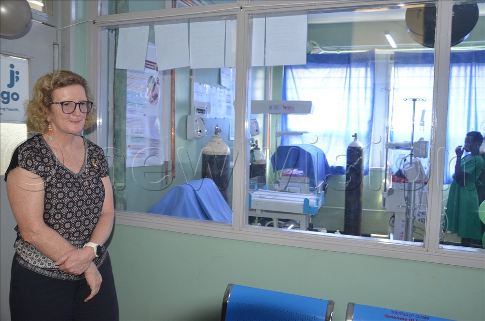 The Irish Ambassador to Uganda, Mags Gaynor, stands beside the NICU after the handover ceremony.
