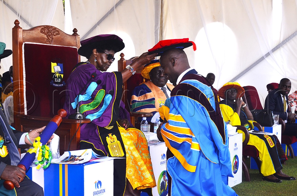 Prof Joy Kwesiga, the Kabale University chancellor, recognising Dr Ivan Habaasa during the Friday graduation ceremony. (Credit: Job Namanya)