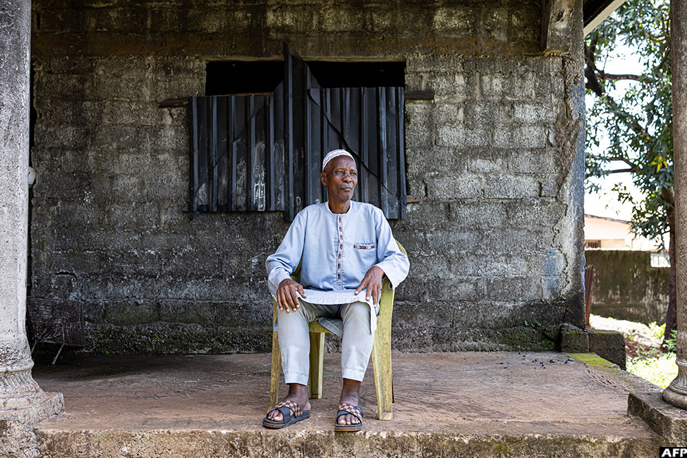 Idrissa Diallo, father of Aladji, poses for a portrait in Conakry.