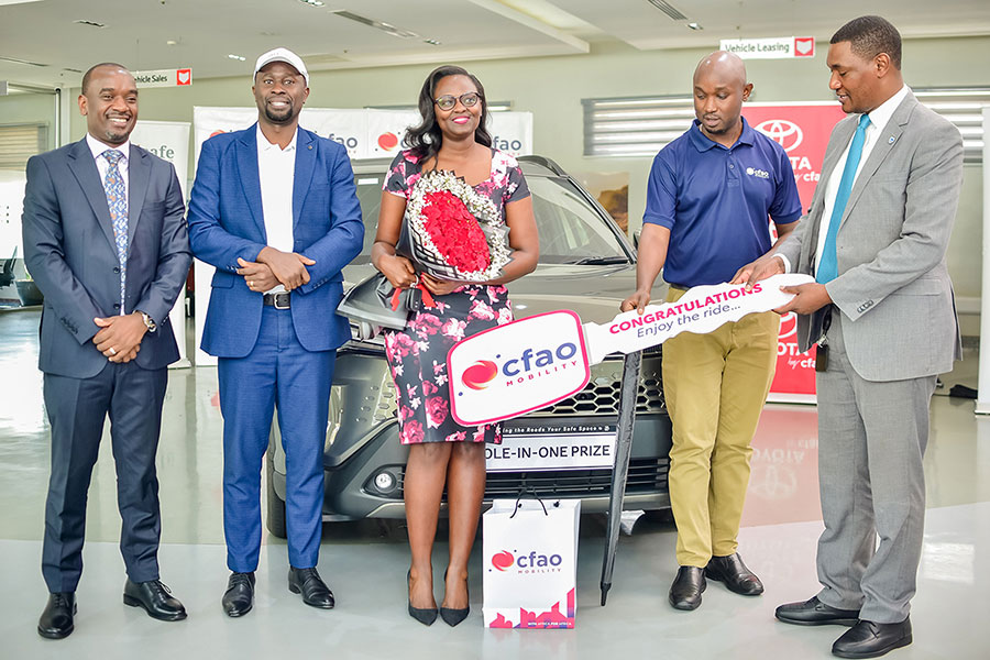 L-R: Entebbe Club captain Serwano Walusimbi, Head of Business Development at AfriSafe Insurance Brokers Arnold Baguma (left)  and CFAO Mobility Marketing Manager Isaac Tegule (2nd right) pose with Berna Musanabera as she receives her car keys. Courtesy photo