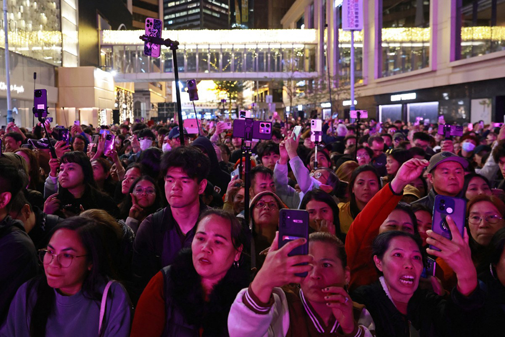 Revellers take photos as they wait for the midnight countdown during New Year&rsquo;s celebrations in Hong Kong on December 31, 2025. (AFP)