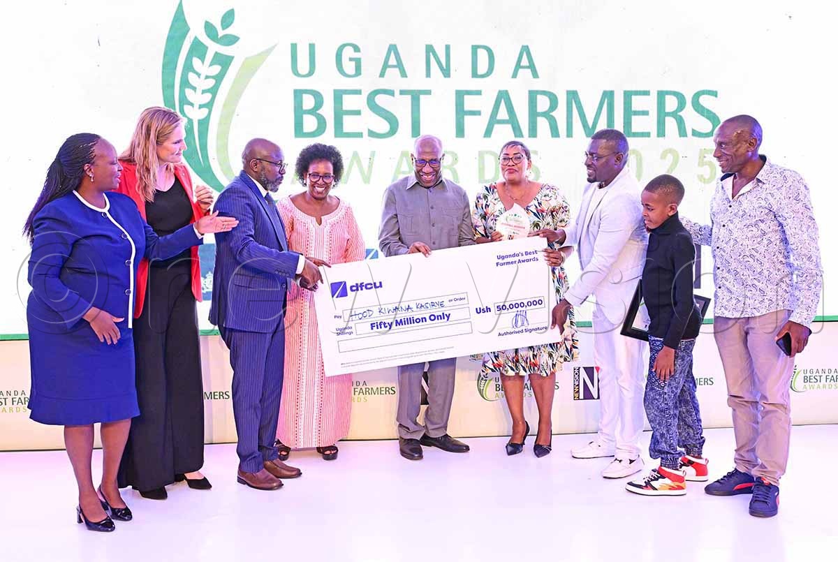(L-R) dfcu Bank&rsquo;s Annette Kiconco, former Netherlands Ambassador to Uganda Frederieke Quispel, Vision Group CEO Don Wanyama, Jocelyn Rugunda and husband ex-premier Dr Ruhakana Rugunda, hand over sh50m cheque to the overall winner of the 2025 Best Farmers Competition, Hood Kasirye Kiwana (3rd right) who was accompanied by family members during the award ceremony on December 10, 2025.