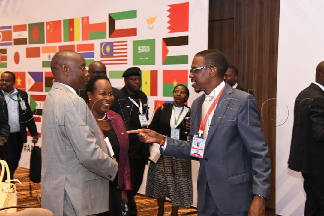 Attorney General Kiryowa Kiwanuka (right) interacting with guests.