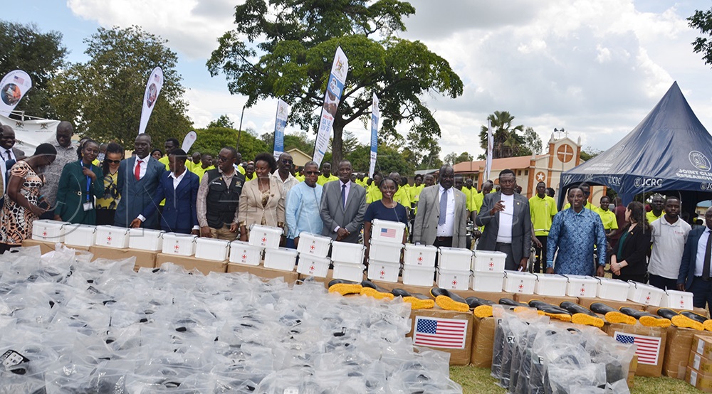 Ministry of Health staff, Omoro district staff and staff from the Joint Clinical Research Centre and the US government pose for photos with the equipment to be given to CHEWs to carry out primary health care in the community. (Photo by Jackson Kitara)