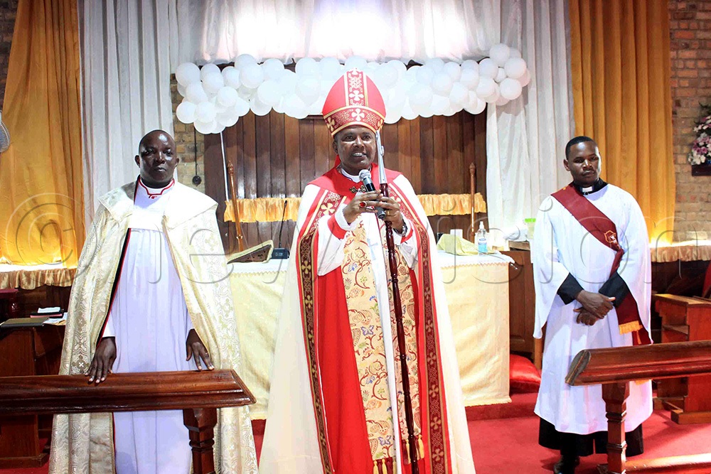 Bishop Enos Kitto Kagodo of Mukono Diocese addressing the congregation during the Christmas service, looking on (left) is Provost Godfrey Ssengendo. (Photo by Henry Nsubuga)
