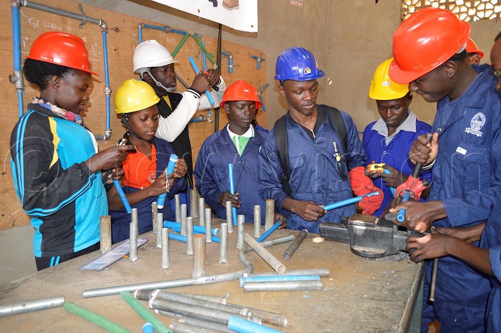Students of plumbing listening to their instructor at an institute in Wakiso district. (Photo by Umar Nsubuga)