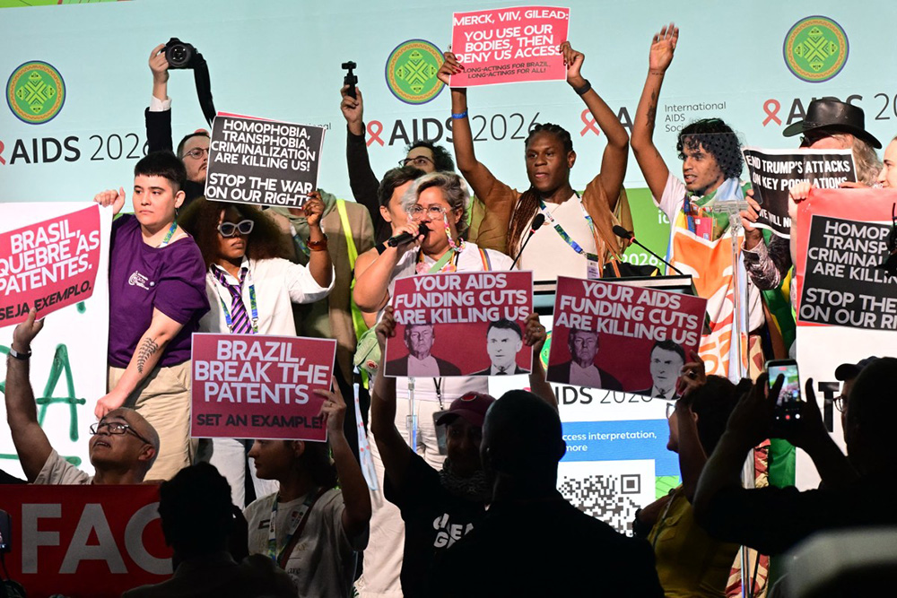 People protest during the opening ceremony of the 26th International AIDS Conference in Rio de Janeiro, Brazil, on July 27, 2026. (Photo by Pablo PORCIUNCULA / AFP)