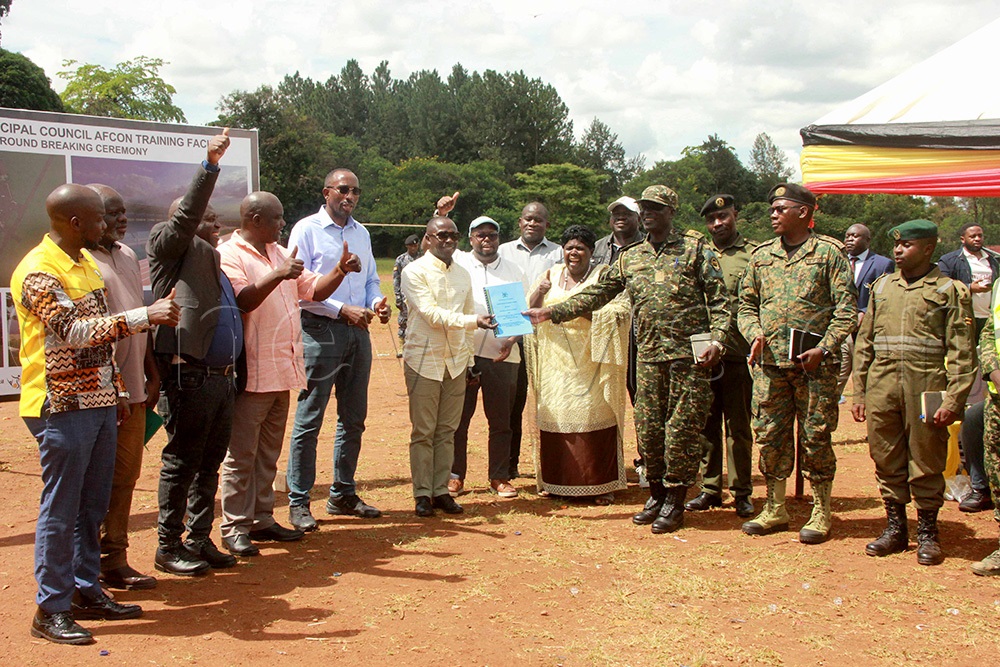  Peter Ogwang, the state minister for Sports handing over the contractal documents to the UPDF engineering brigade as they launched the construction of the training play grounds. (Photo by Peter Abaanabasazi)