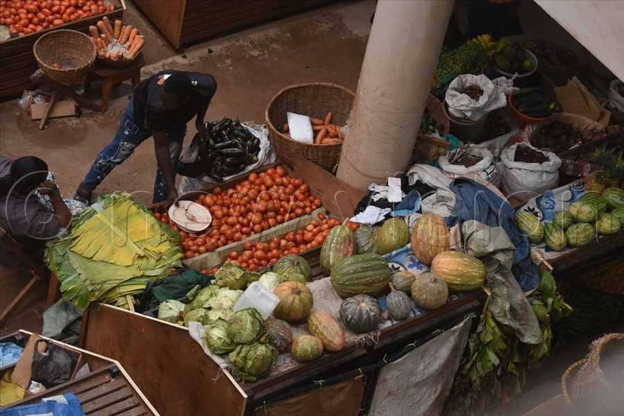 Inside the market, vendors carefully sort and arrange fresh tomatoes, beans, a colourful variety of spices and fruits across their stalls. (All Photos by Davis Buyondo)