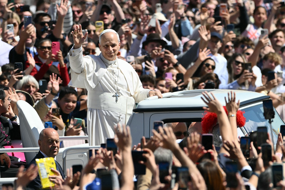 Pope Leo XIV waves to the crowd from the popemobile after the Easter Mass as part of the Holy Week celebrations, at St Peter's square in the Vatican on April 5, 2026.