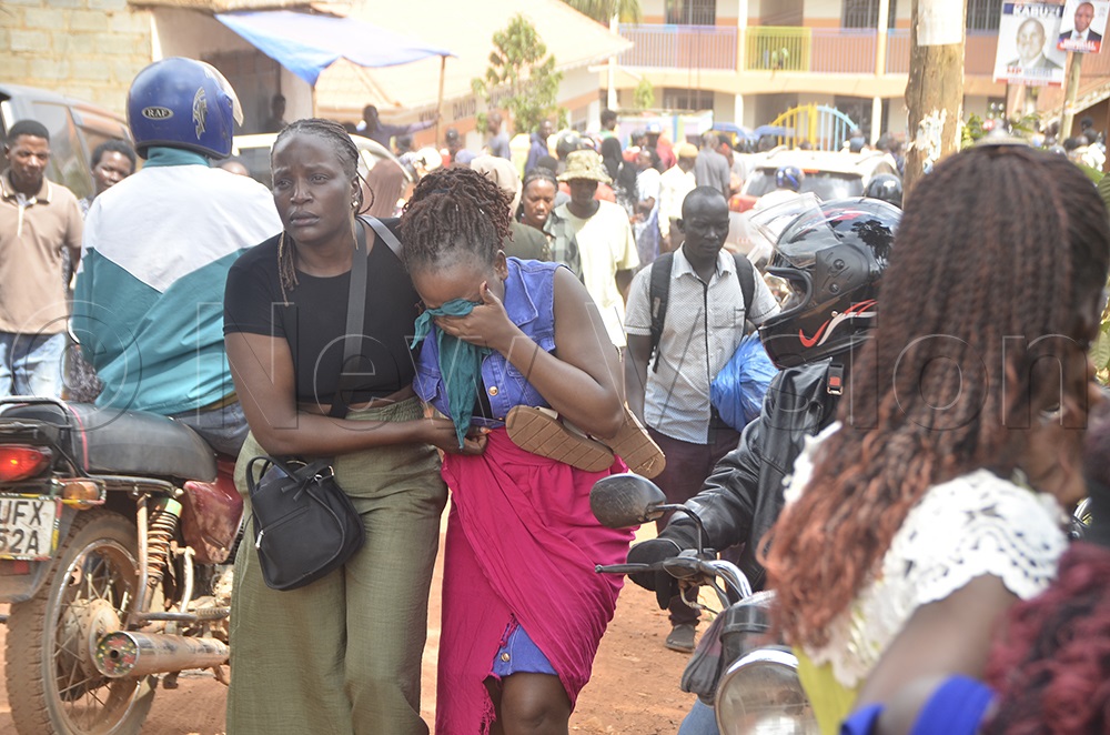 A parent is comforted following the incident. (Photo by Nicholas Kajoba)