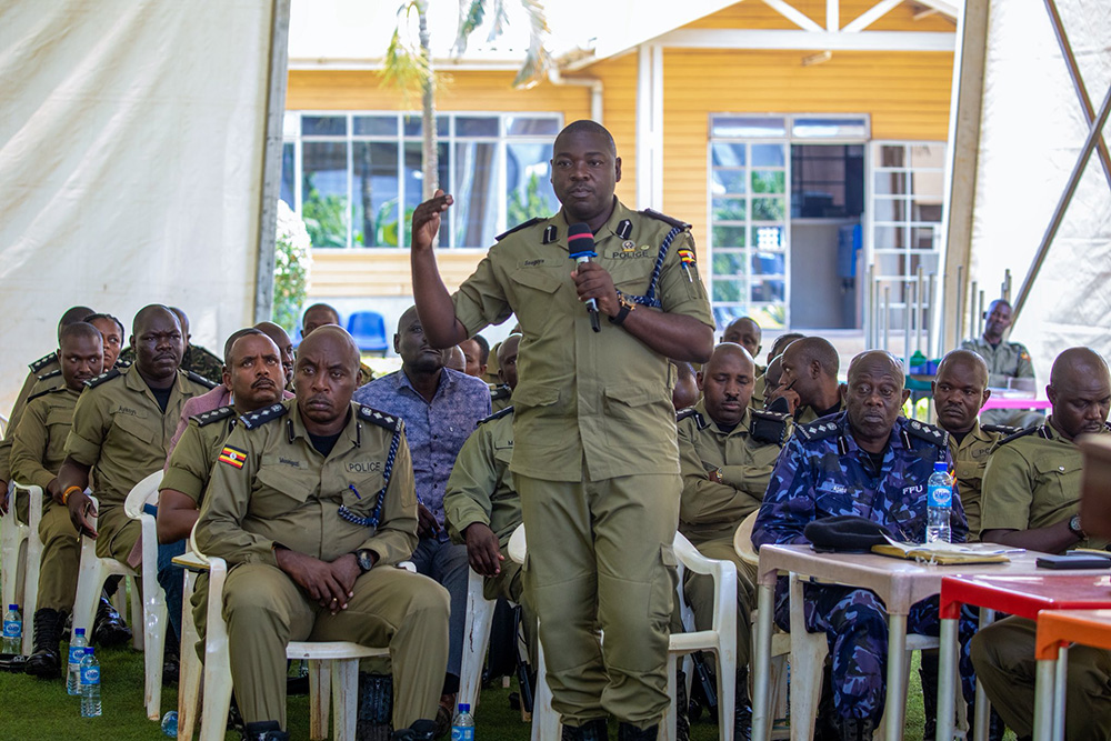  Police officers deliberating during the joint security meeting held at Naguru Police headquarters. (Credit: Uganda Police)