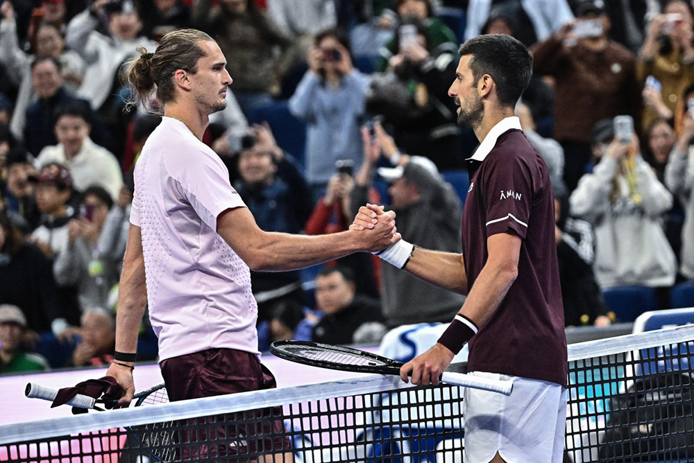 Serbia's Novak Djokovic (R) shakes hands with Germany's Alexander Zverev after their men's singles quarter-final at the China Open tennis tournament in Beijing on October 4, 2026.