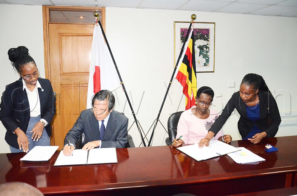 Ambassador of Japan to Uganda, Sasayama Takuya and permanent secretary ministry of health, Diana Atwine, signing grant contracts at the embassy in Kampala. (Photo by Isaac Nuwagaba)