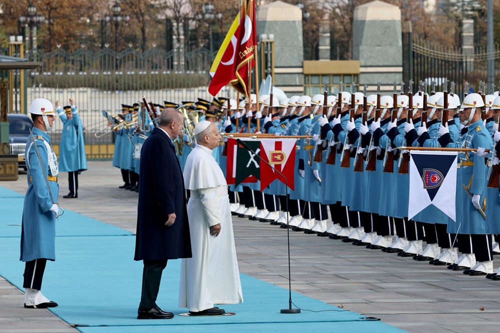 Pope Leo XIV (R) review troops with Turkey's President Recep Tayyip Erdogan (L) during a welcoming ceremony upon his arrival for a meeting at the presidential palace in Ankara on November 27, 2025. 