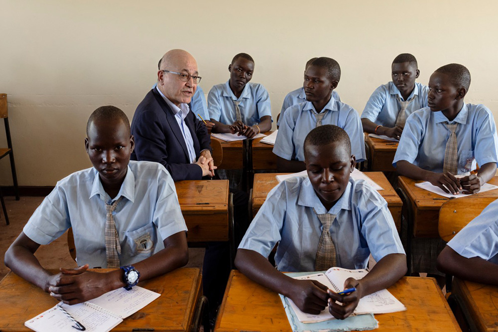 United Nations (UN) High Commissioner for Refugees, Barham Salih (2nd L) joins students at an all girl's schools run by the Big-Heart Foundation during a lesson following his arrival at the Kakuma refugee complex in Kakamu on January 11, 2026. (Photo by Tony KARUMBA / AFP)