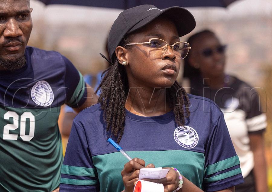 St. Charles Lwanga Ntinda Volleyball Club team with coach Casandra Nabatanzi (R) taking notes during a league game in Nsambya
