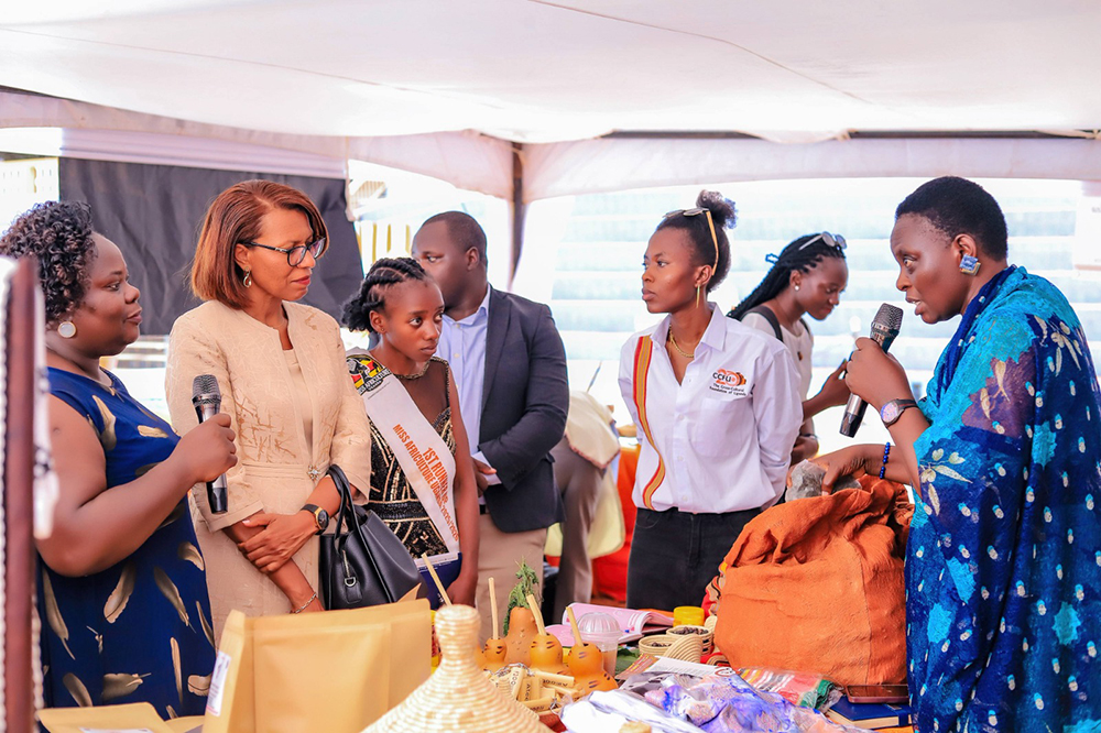 Alice Basemera, founder of the Koogere Foundation, takes visitors through cultural exhibits at her stall. (Courtesy)