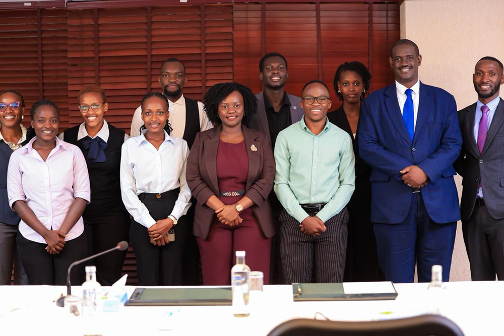 The team part of the Judicial Service Conversations including Loyola Rwabose Karobwa (middle front row) and Elison Karuhanga (second from right), pose for a photo after conversations. (Courtesy photo)