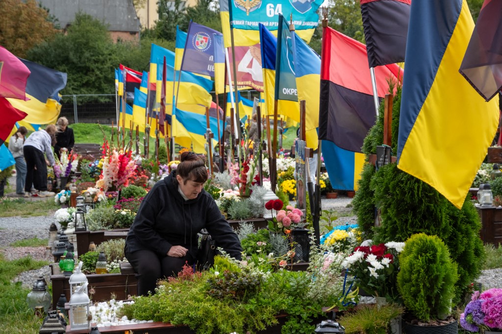 Civilians, military personnel and relatives of fallen soldiers attend a ceremony to honor the Heroes of Ukraine who died in the Russia-Ukrainian War on Ukraine's Independence Day at the burial grounds of the Lychakiv Cemetery, in Lviv, Ukraine on August 24, 2025. 