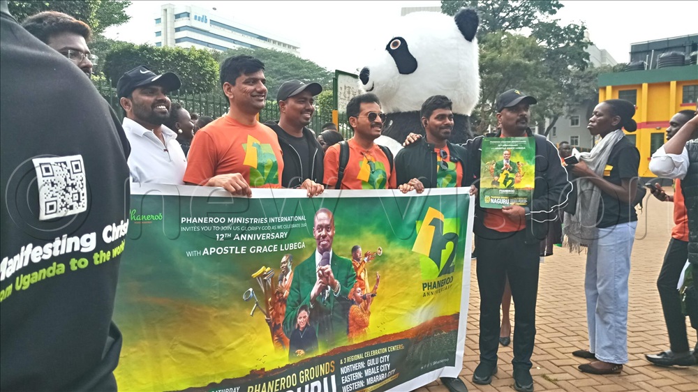 Some of the visiting team from abroad holding a poster during the launch of 12th anniversary of Phaneroo Ministries International at Constitutional Square in Kampala.