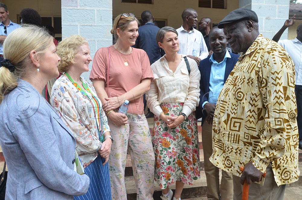 Karamoja affairs minister Peter Lokeris shares a moment with the ambassadors at the Moroto district chamber hall. (Photo by Olandason Wanyama)