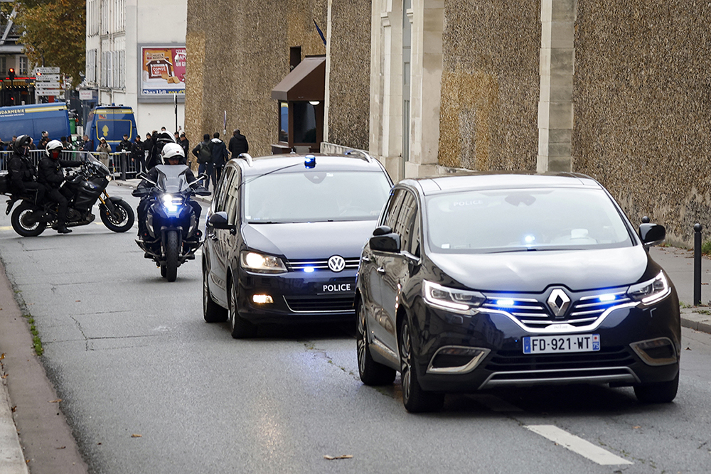 The car (R) believed to belong to former President Nicolas Sarkozy leaves the Sante prison in Paris on November 10, 2025. French prosecutors on November 10, 2025 requested the release from prison of former president Nicolas Sarkozy under judicial supervision pending an appeals trial over allegations that he sought Libyan funding. 