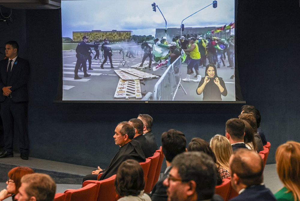 Handout picture released by Brazilian Supreme Court shows a TV projecting images of a protest in Brasilia on January 2023, during a session to decide if former President Jair Bolsonaro will face trial. (AFP Photo)