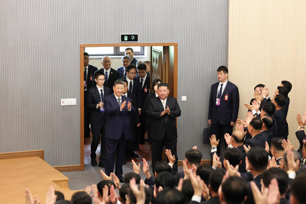 Xi Jinping, general secretary of the Communist Party of China Central Committee and Chinese president, walks into a lecture hall of the Central Cadres Training School of the Workers' Party of Korea (WPK) in the company of Kim Jong Un, general secretary of the WPK and president of the State Affairs of the Democratic People's Republic of Korea (DPRK), in Pyongyang, the DPRK, June 9, 2026. (AFP)