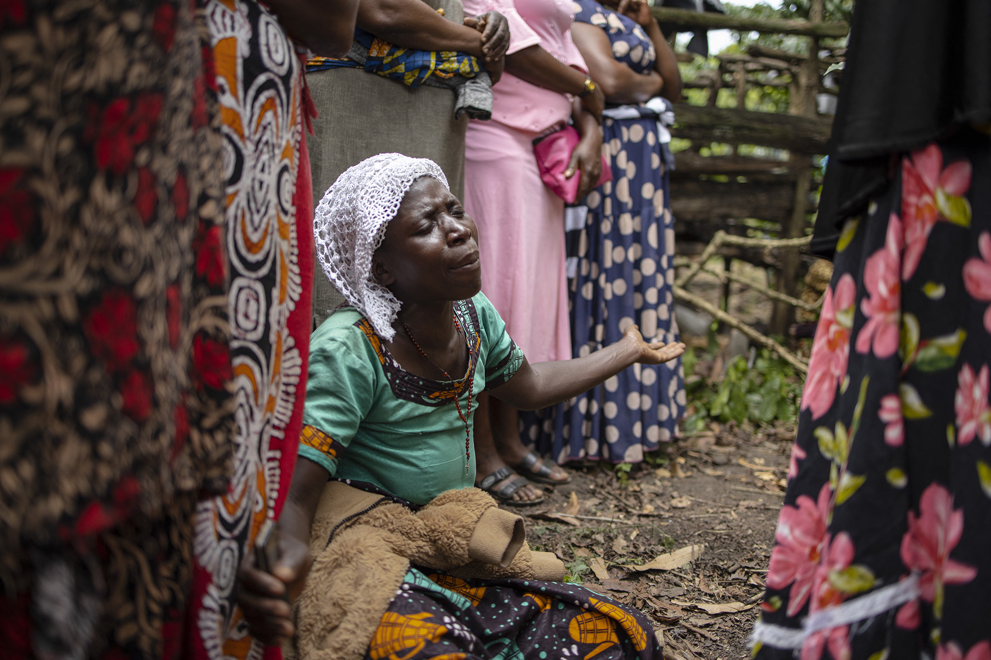 A woman mourns during a funeral. 