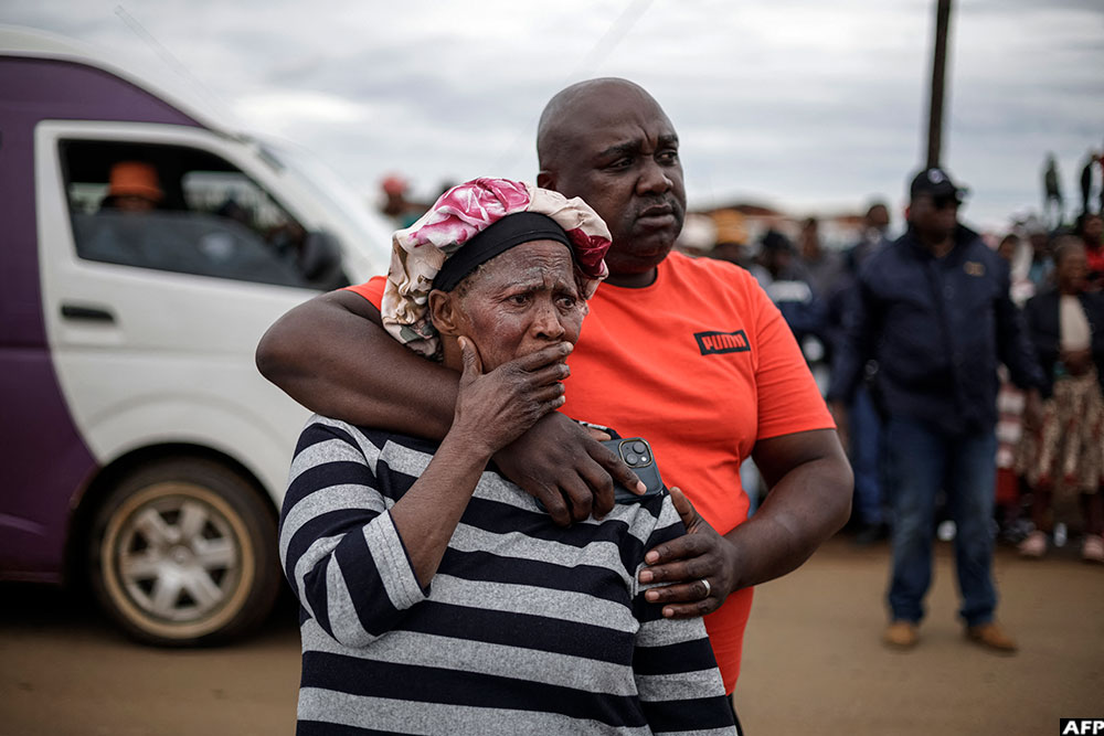  Family members of a victim react at the scene of an attack at a tavern in Bekkersdal on December 21, 2025