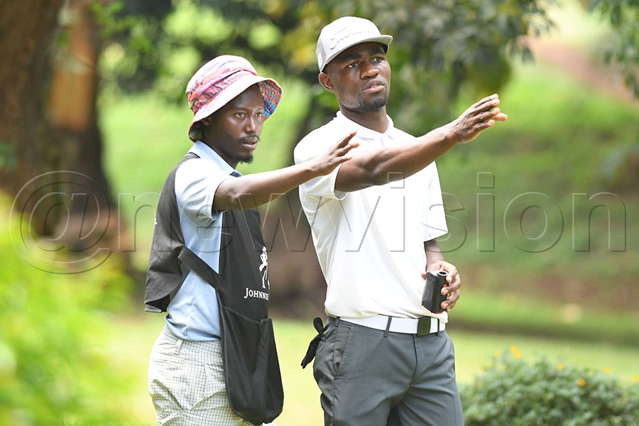 Zambian golfer Gilbert Chalwe (right) and his caddie plan their approach on the 17th tee during the second round of the Uganda Open at Kitante, August 26, 2026. Photo by Michael Nsubuga