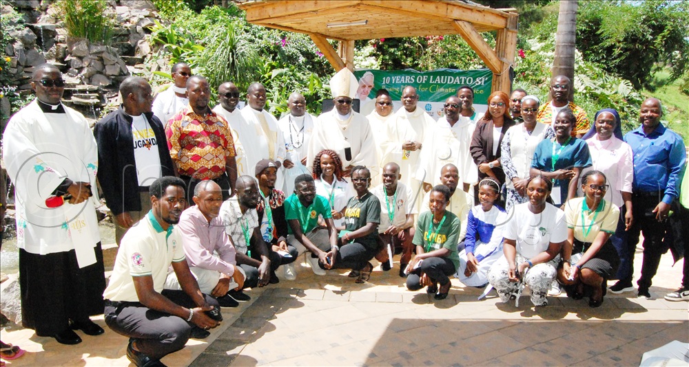 Archbishop Paul Ssemogerere (wearing a white mitre) shares a photo moment wiith some of the environment conservation activists who graced the celebration of the 10th anniversary of Laudato Si, at Uganda Martyrs Catholic Shrine Munyonyo, in Makindye Division on May 16 (2025). 