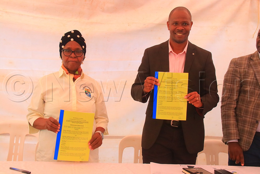 Kabale University Vice Chancellor Prof. Joy Kwesiga (Left) with National Forestry Authority led by Executive Director Stuart Maniraguha after signing the MoU. (Credit: Nelson Ahimbisibwe)