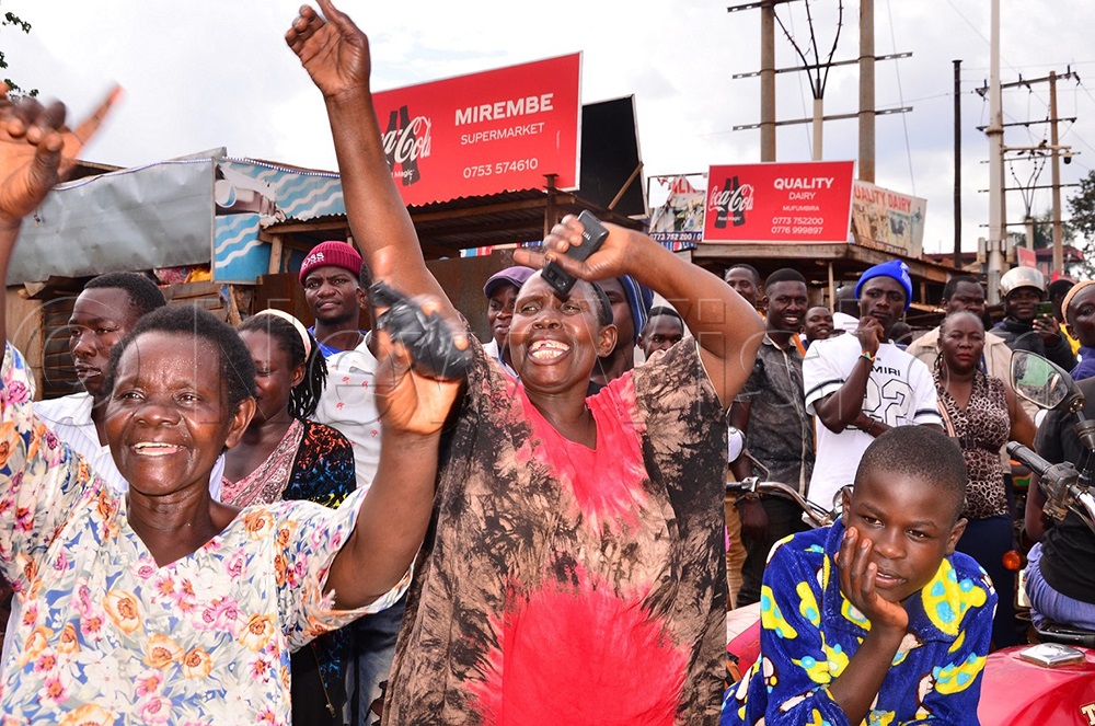 Sonia Nalumansi (in a red and black dress) and a colleague cheering Kasibante in Mafubira after announcing his plan of naming Kadaga Vice President once voted into the top seat. (Photo by Jackie Nambogga)