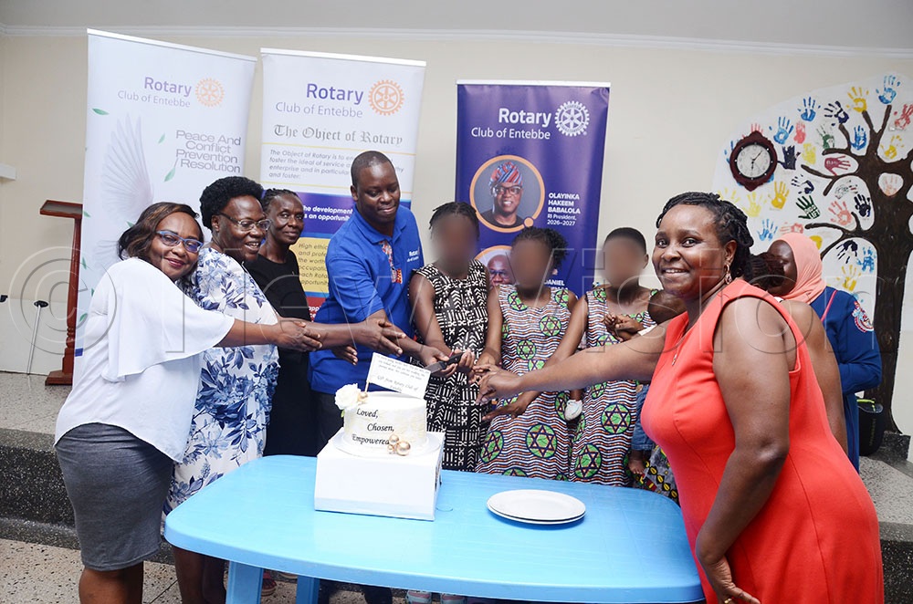 Some of the members of the Rotary Club of Entebbe led by Arthur Byara (blue t-shirt) the club president join some of the staff and teenage mothers at Wamukisa Youth Centre in Kitara Wakiso district to cut cake during their charity visit to the centre on September 30, 2026. (Credit: Lawrence Mulondo)