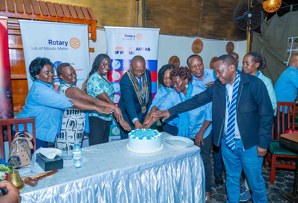 Members of the Rotary Club of Ntinda Metro cutting the cake with the District Governor D9213 Rtn. Geoffrey Martin Kitakule. (Photo by Jovita Mirembe)