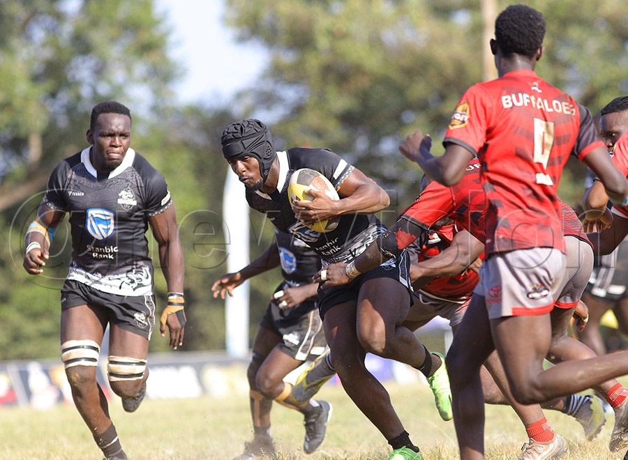 Pirates' Desire Ayera with the ball against Buffaloes opponents during the Rugby Premiership final. Pirates won 30-29. PHOTO BY JOHNSON WERE