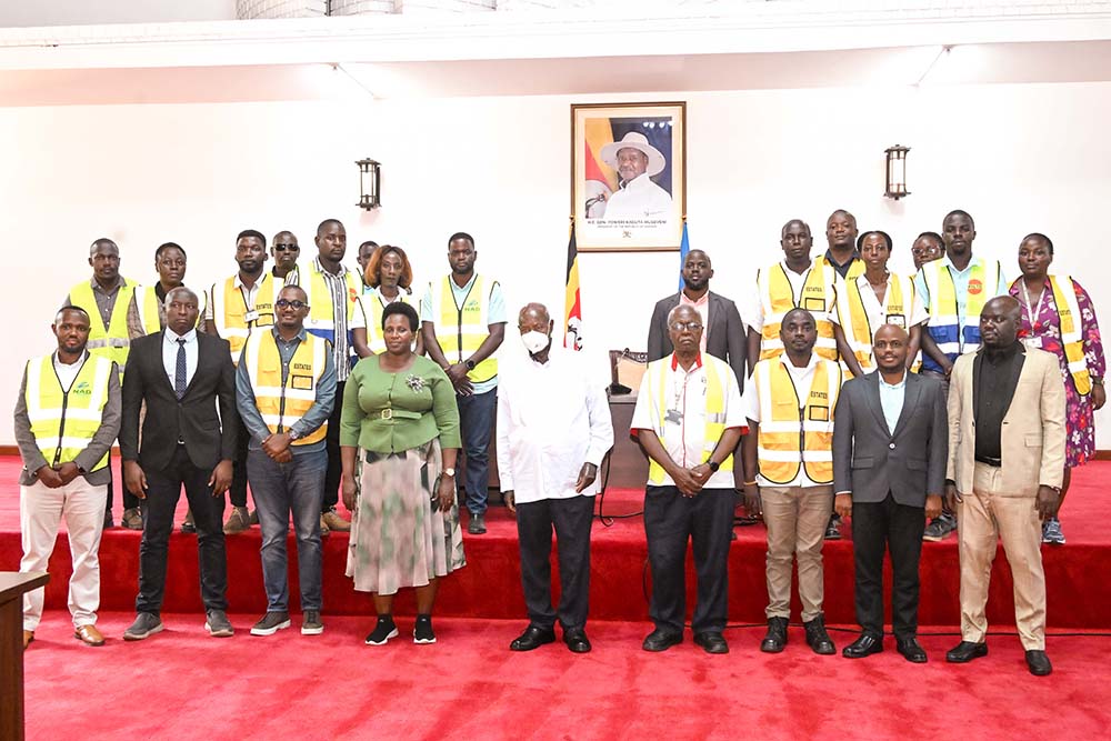  President Museveni shares a photo moment with some of the staff of State House Estates Department after commissioning the SFC detach dormitory at Nakasero on Wednesday. Also in photo is State House Comptroller.
