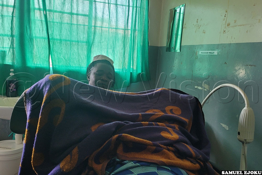 Sister Mary Anyango, a midwife, screening a woman for cervical cancer at the screening unit at Soroti Regional Referral Hospital