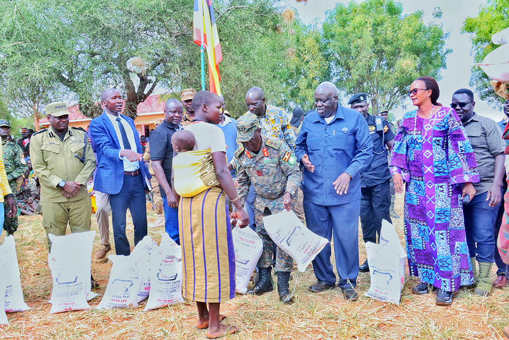 A woman waits to be given a bag of posho and rice during the launch of relief food distribution in Kabong district. (Courtesy photo)
